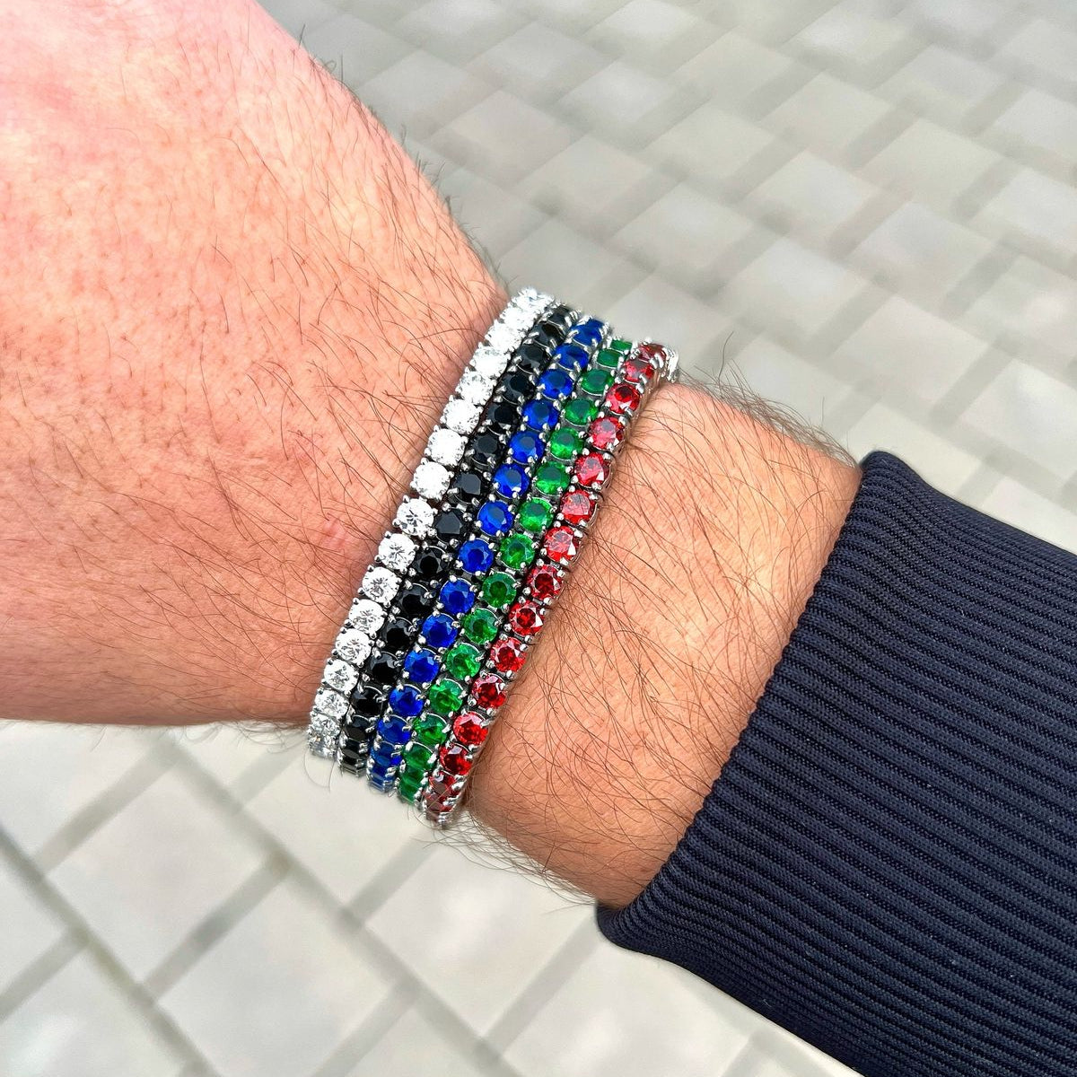 Multicolored beaded bracelet on a wrist with a tiled floor background