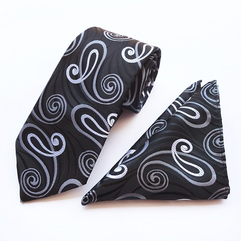 A stylish black  tie paired with a classic black and white pocket square, showcasing elegant fashion details