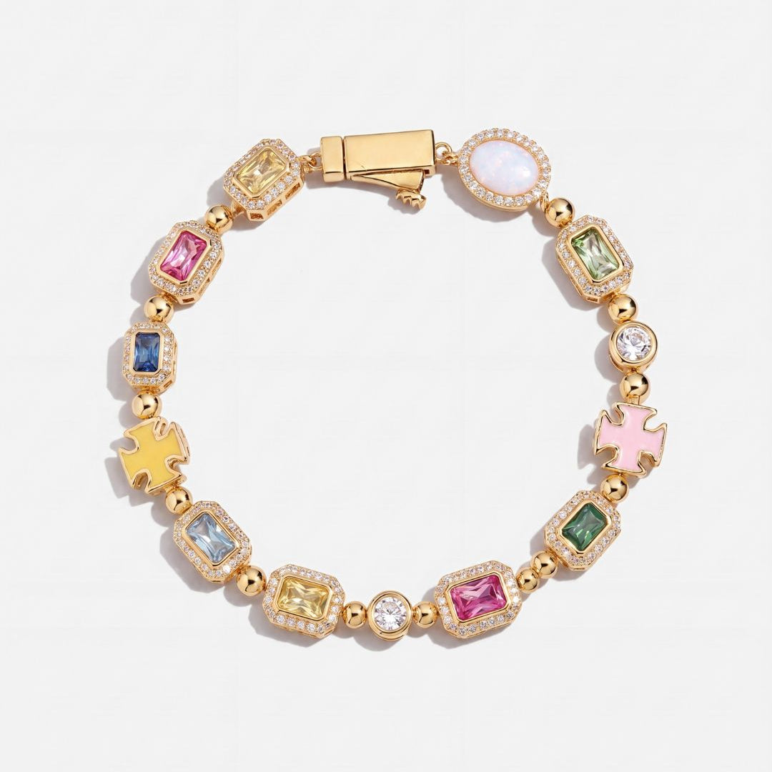 Gold bracelet with colorful gemstones on a white background