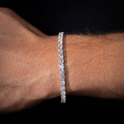 Diamond bracelet on a wrist against a dark background