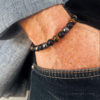 Close-up of a person wearing a beaded bracelet on their wrist.