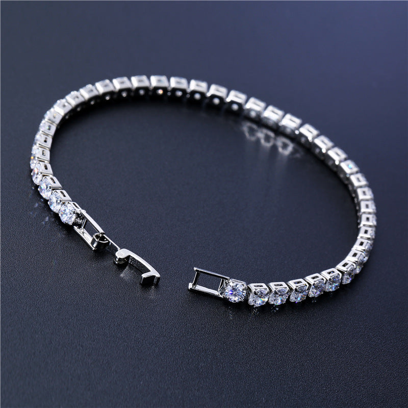 Silver bracelet with clear stones on a dark background