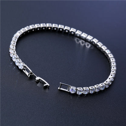 Silver bracelet with clear stones on a dark background