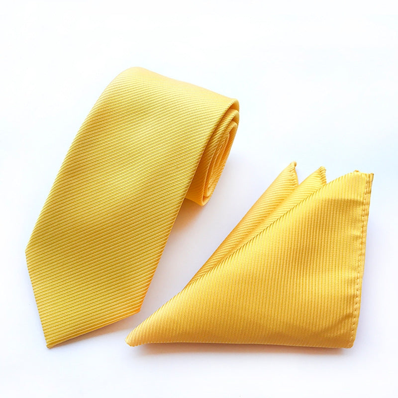 Solid yellow tie complemented by a sophisticated pocket square, perfect for formal attire.
