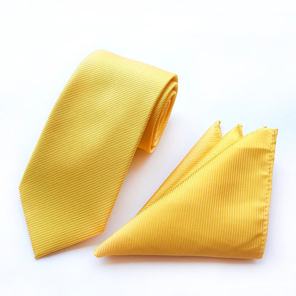 Solid yellow tie complemented by a sophisticated pocket square, perfect for formal attire.