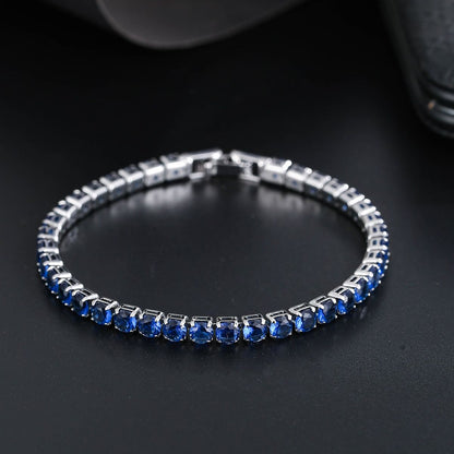 Silver bracelet with blue stones on a dark background