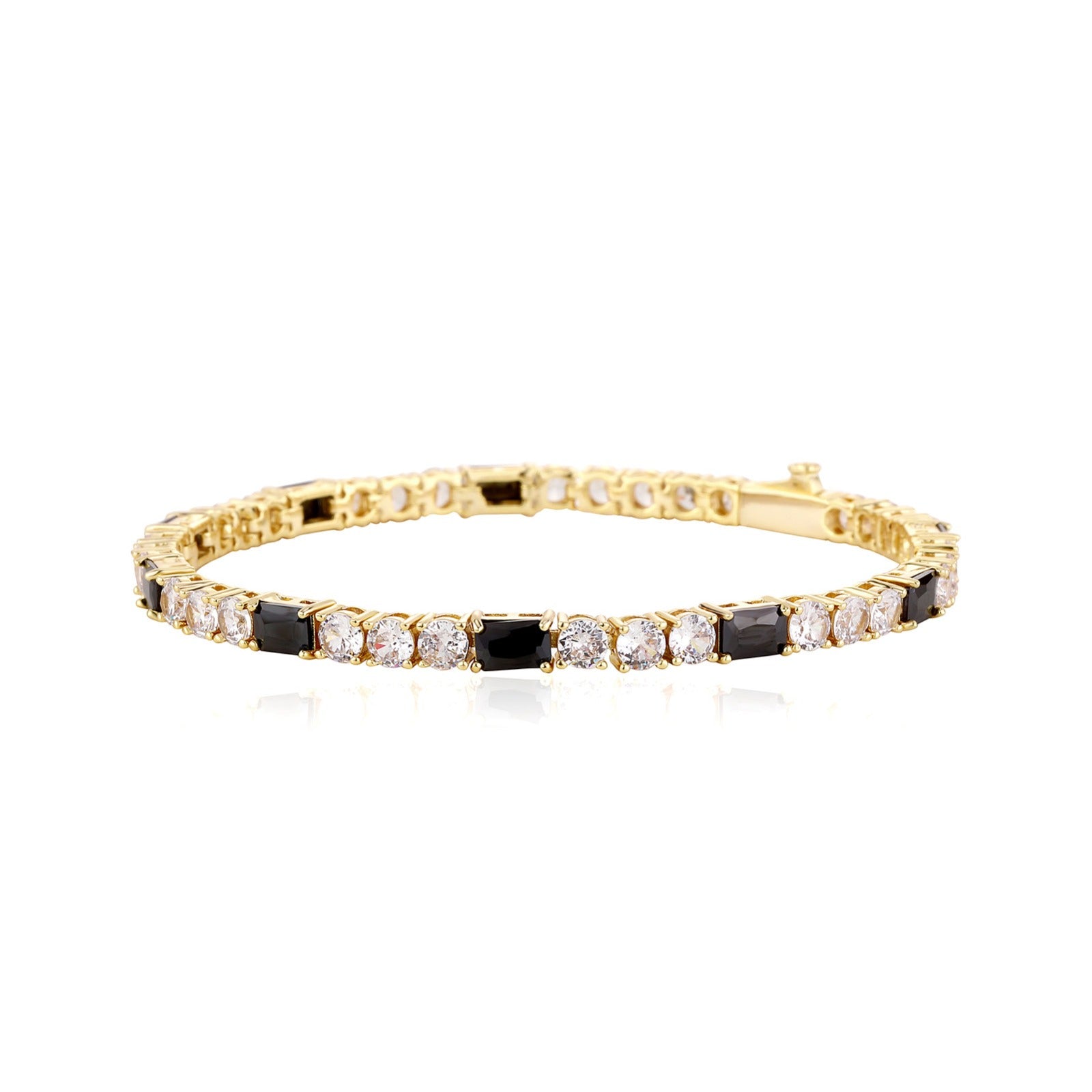 Gold bracelet with black and clear stones on a white background