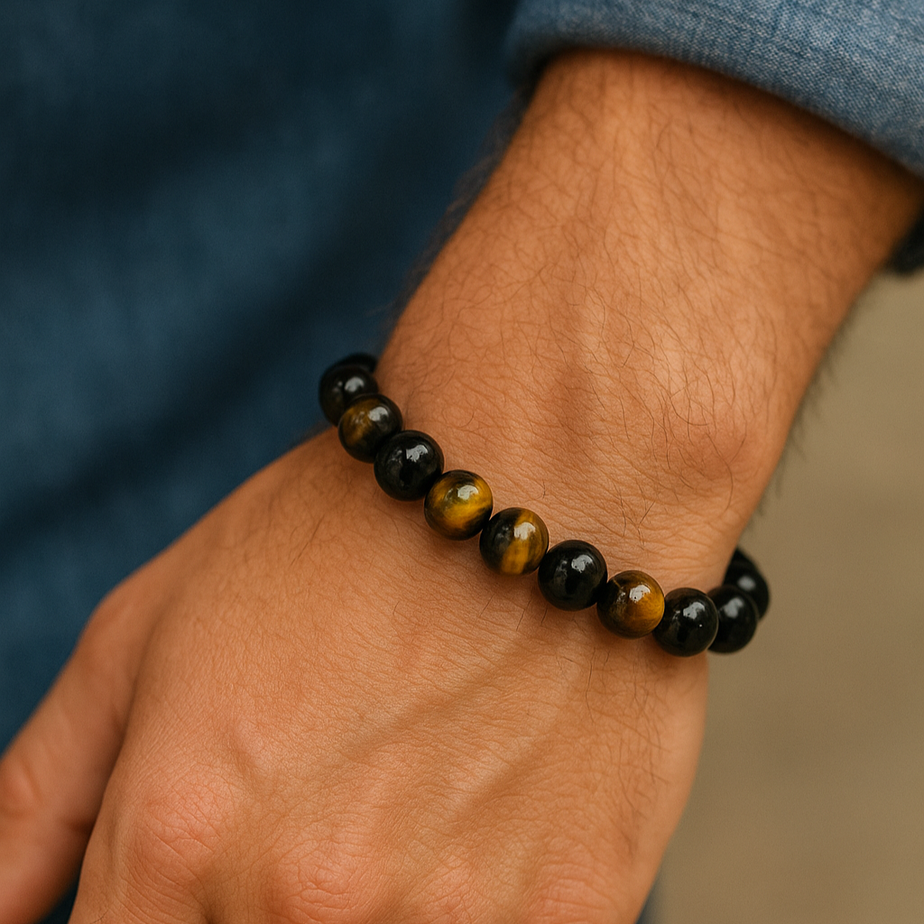 Hand wearing a black beaded bracelet on a blurred background